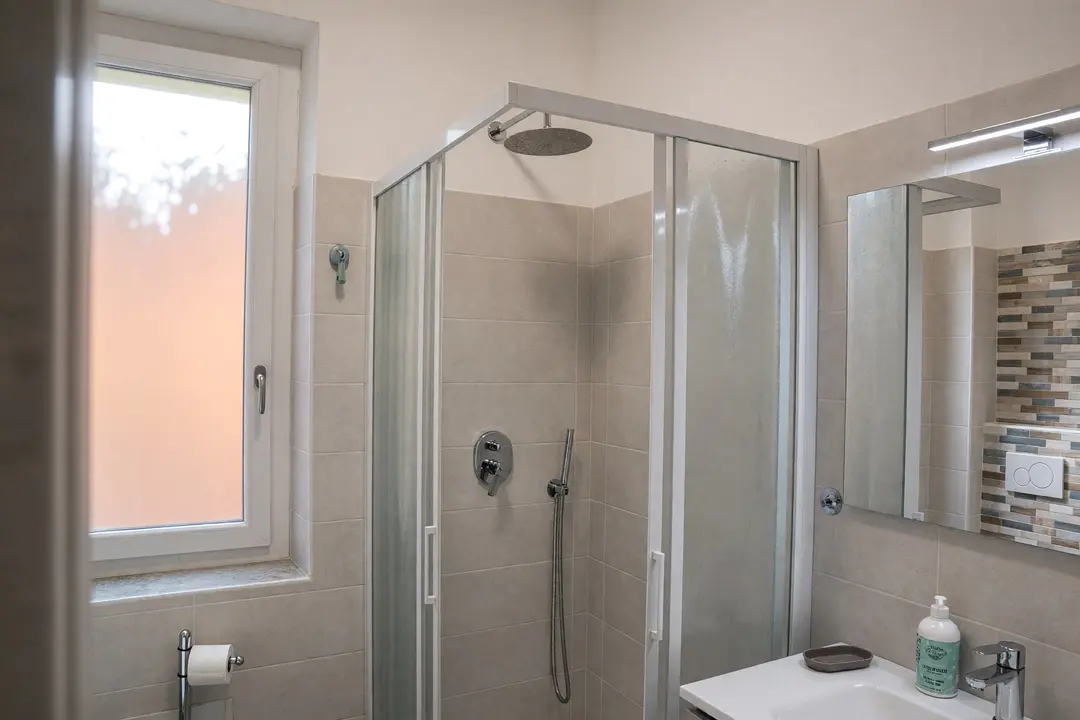 Il bagno dell’appartamento Basilico, con la finestra e il box doccia